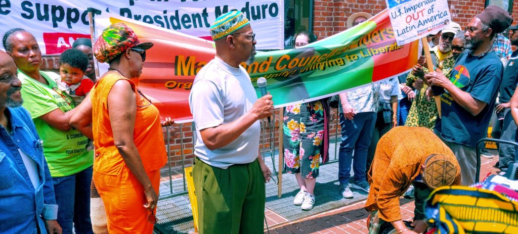 Photo of a group of Black elders with a banner that reads "Maryland Council of Elders: Organizing to Unify! Unifying to Liberate!"
